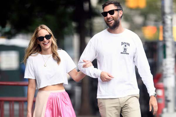 Jennifer Lawrence and Cooke Maroney walking down in street.